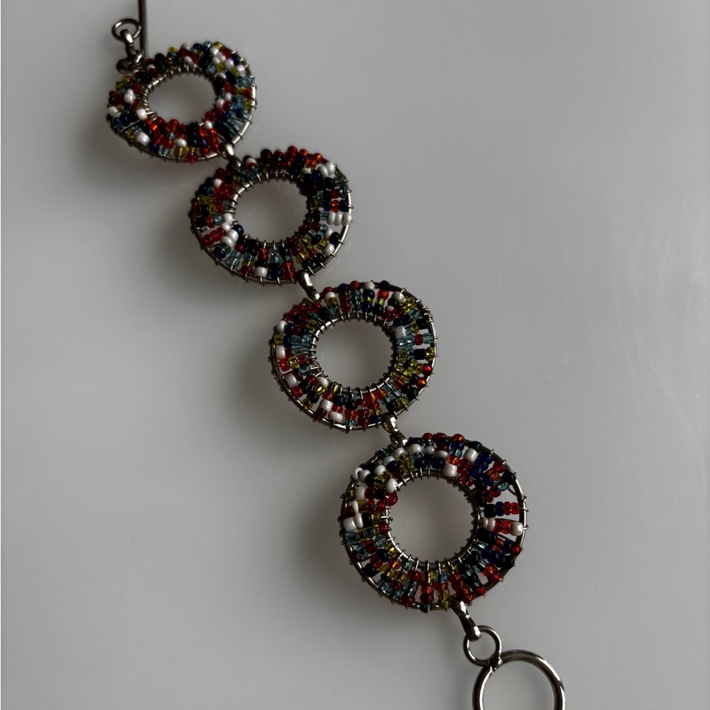 Doughnut hole beaded bracelet/ silver tone/ measures 7.5 in length